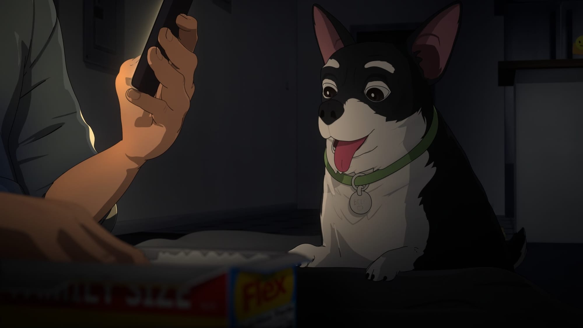 Robert is reading his phone while his dog Beef is panting with tongue out, hoping to get some of Robert's cereal he's having for dinner.